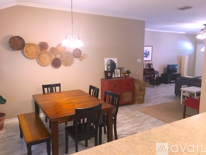 A dining room with a wooden table and chairs.