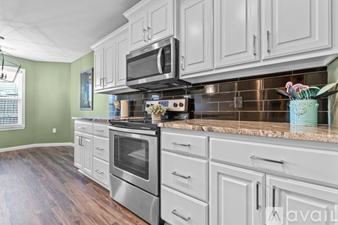 A kitchen with a stove top oven and a microwave above it.
