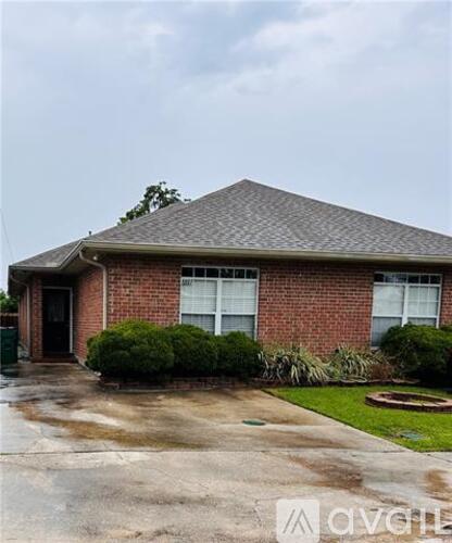 A house with a grey roof and a brick wall.