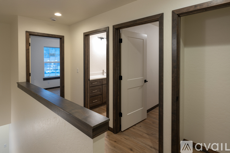 A hallway with a window, a door, and a counter.
