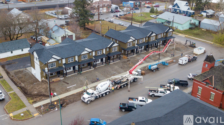A cement truck is parked in front of a building.