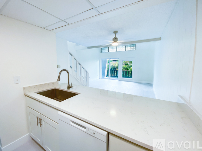 A kitchen with a sink and a window.