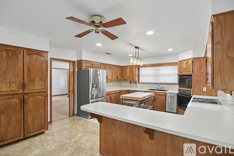 A kitchen with wooden cabinets and a white countertop.