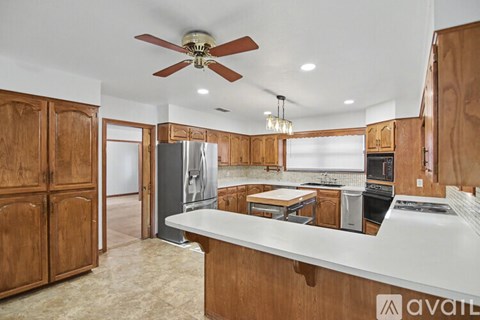 A kitchen with wooden cabinets and a white countertop.