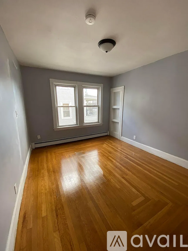 A room with wooden floors and a window.