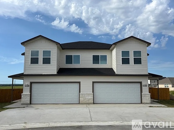 A two-story house with a garage on the ground floor.