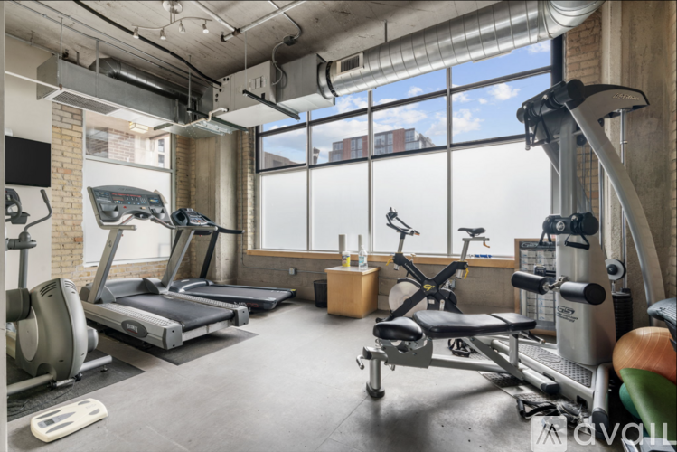 A well-equipped gym with treadmills, elliptical machines, and other exercise equipment.