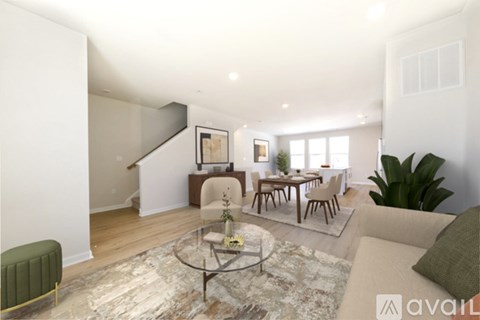 A living room with a glass coffee table and a green armchair.
