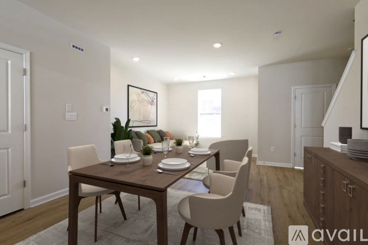 A dining room with a wooden table and chairs.