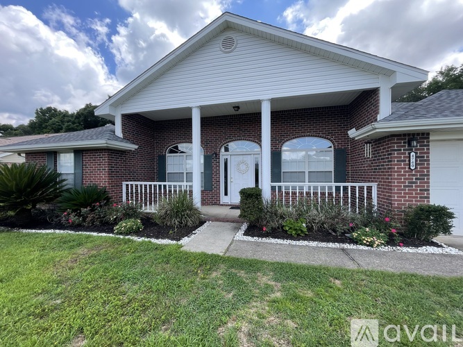 A house with a white front porch and a brick exterior.
