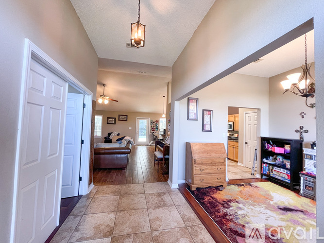 A living room with a rug and a television.