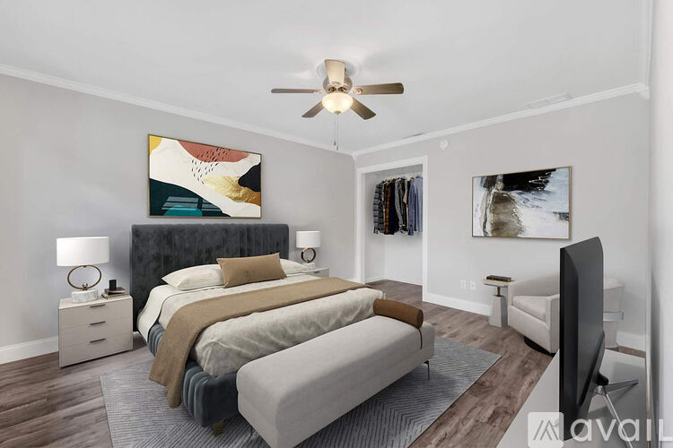 A bedroom with a large bed and a ceiling fan.