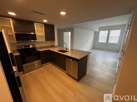 A kitchen with a black stove top oven and a black refrigerator.