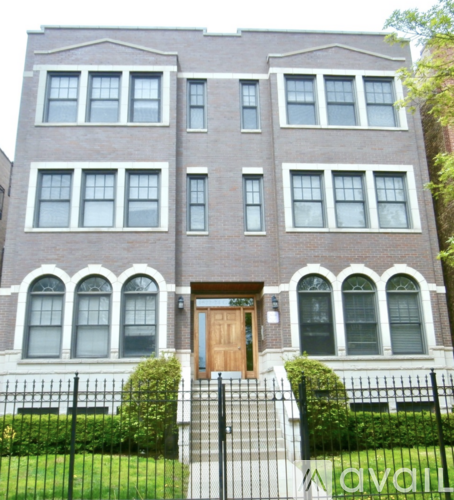 A large brick building with a wooden door and windows.