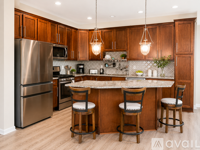 A kitchen with wooden cabinets and a marble countertop.