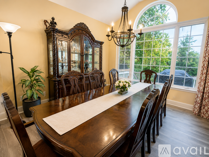 A dining room with a wooden table and chairs.