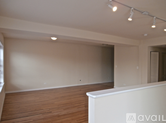 A room with wooden floors and white walls.