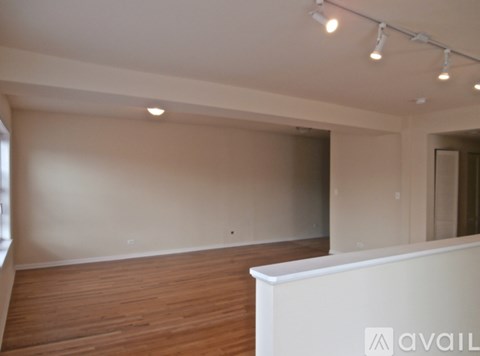A room with wooden floors and white walls.