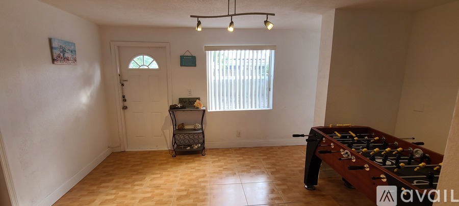A room with a pool table and a cart.