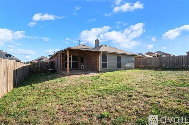 A house with a fence and a grassy yard is for sale.