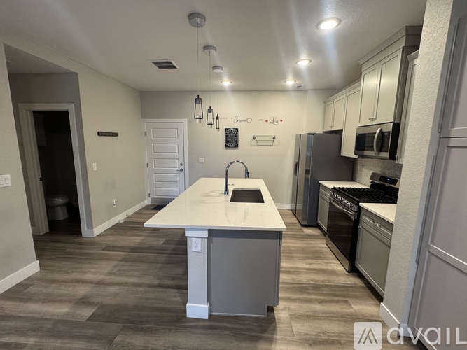 A kitchen with a white island in the middle of the room.