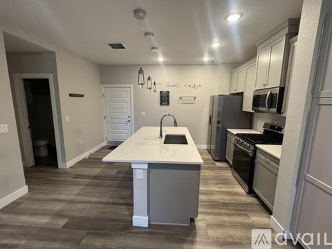 A kitchen with a white island in the middle of the room.
