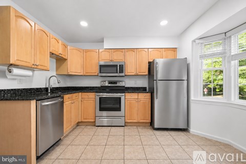A kitchen with wooden cabinets and stainless steel appliances.