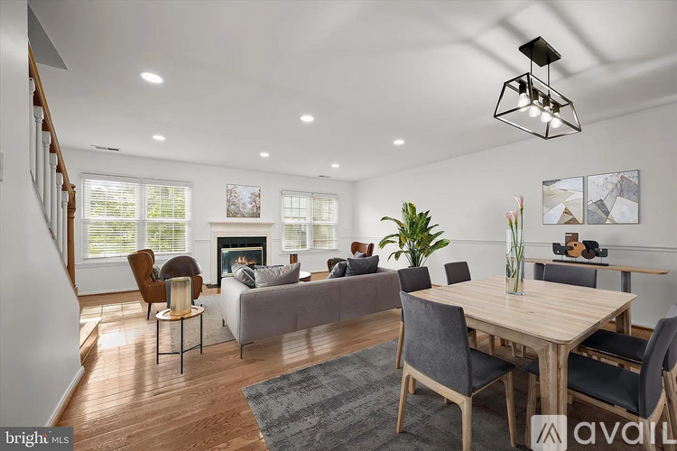 A modern living room with a fireplace and a dining table.