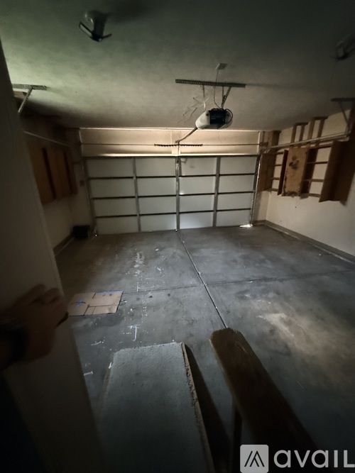 A room with a concrete floor and a ceiling fan.