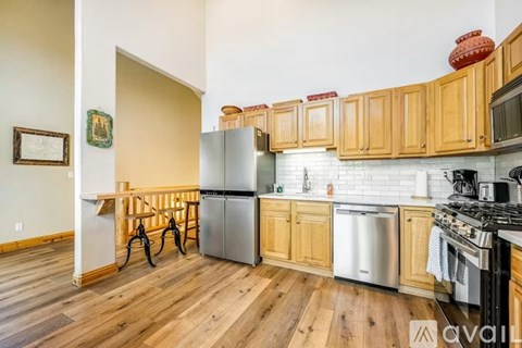 A kitchen with wooden cabinets and stainless steel appliances.