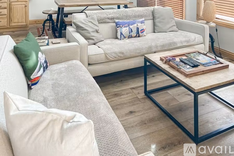 A living room with a grey couch, a coffee table, and a bicycle.