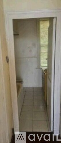 A white door is open to a hallway.