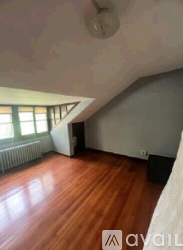 A room with wooden floors and a window.