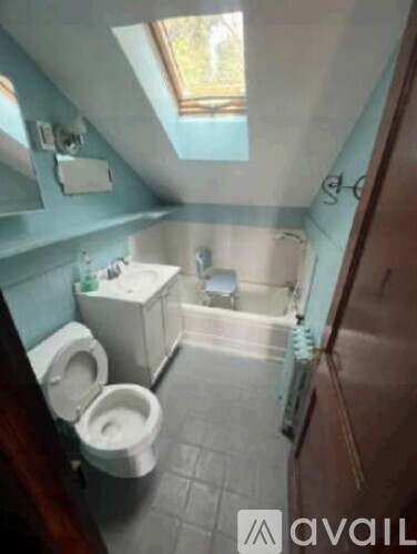 A bathroom with a toilet, sink, and bathtub.
