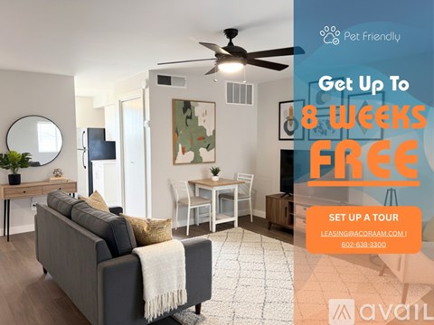 A living room with a grey sofa and a fan on the ceiling.
