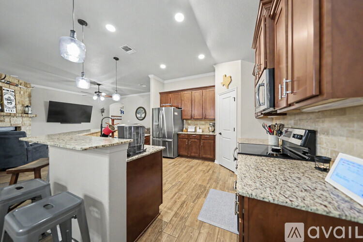 A kitchen with a counter and a fridge.