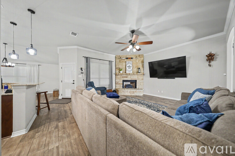 A living room with a beige couch and a fireplace.