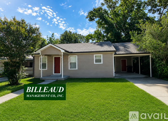 A house with a red door and a sign that says "BILLEAUD MANAGEMENT CO., INC."