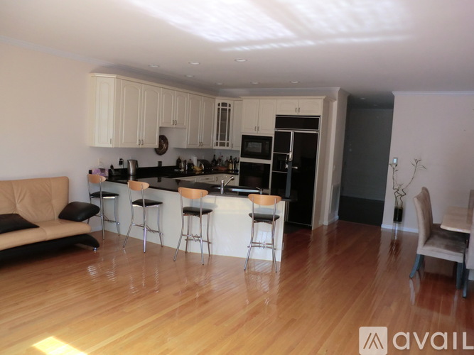 A kitchen with a bar area and a dining table.