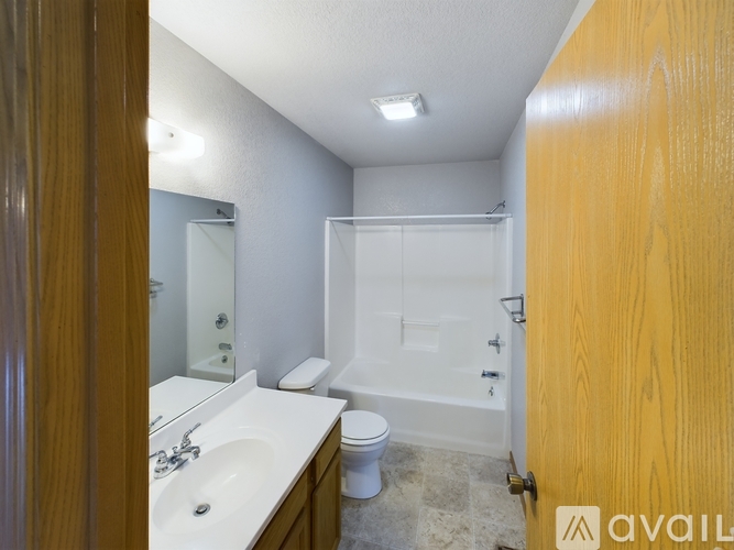 A bathroom with a sink, toilet, and bathtub.