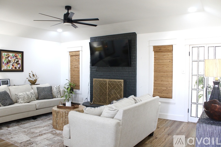 A living room with a fireplace and a television.