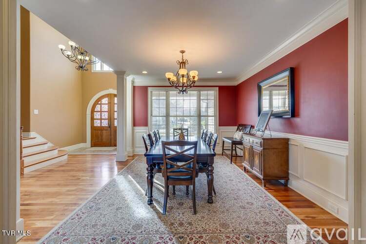 A dining room with a table set for six.