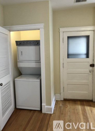 A small kitchen with a refrigerator and oven built into a cabinet.