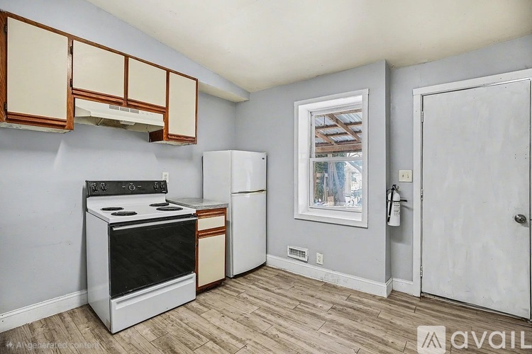 A kitchen with a stove, oven, and cabinets.