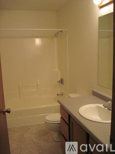 A bathroom with a toilet, sink, and bathtub.