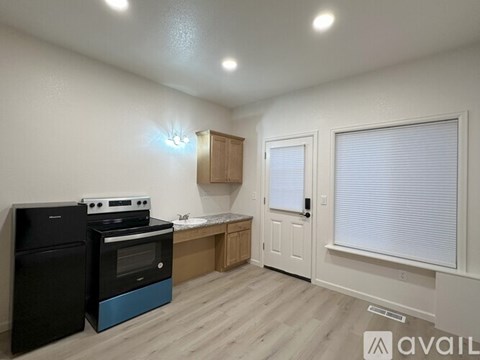 A kitchen with a black oven and a blue oven.