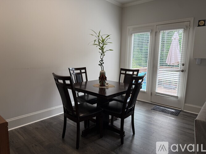 A dining room with a table and chairs.