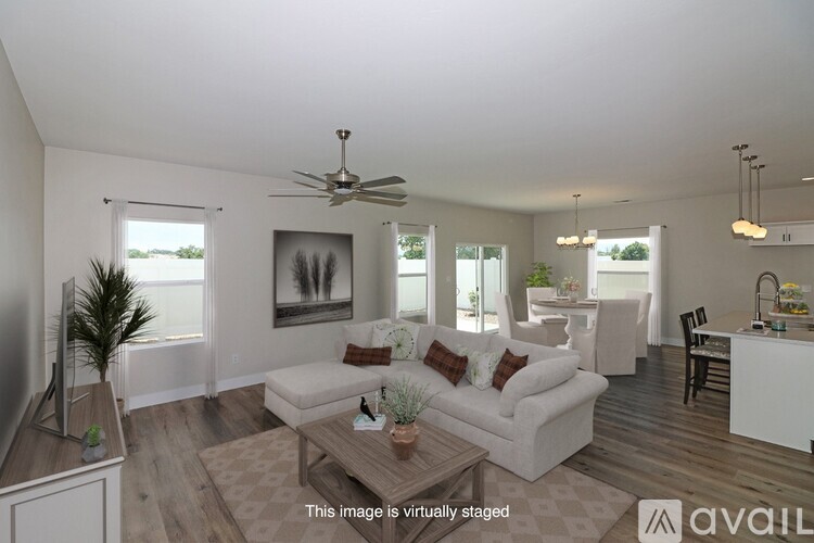 A living room with a white couch and a wooden coffee table.
