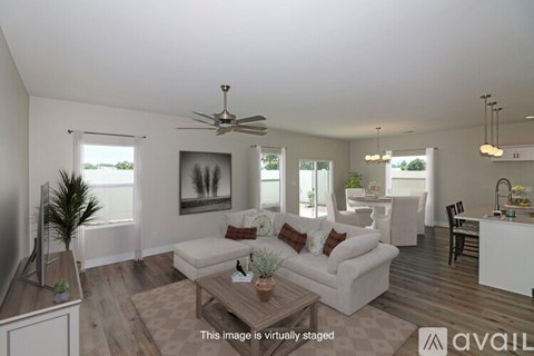 A living room with a white couch and a wooden coffee table.