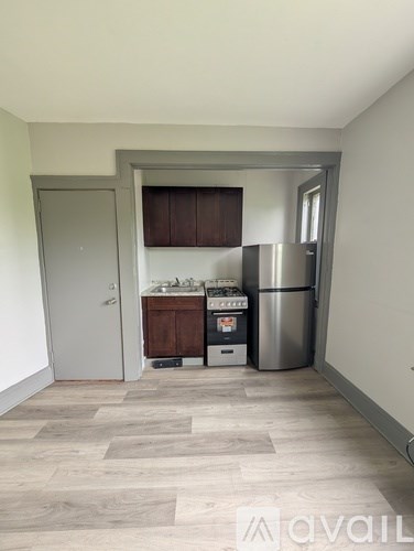 A kitchen area with a stainless steel refrigerator, a stove, and a sink.